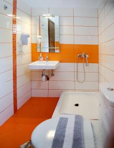 a bathroom with a bath tub and a sink at Livari Studios in Vourvourou