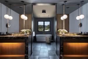 Four Seasons Resort Napa Valley في كاليستوغا: حمام مع مغسلتين وحوض استحمام