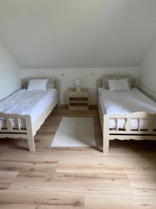 A bed or beds in a room at Várárok Vendégház - Miskolc