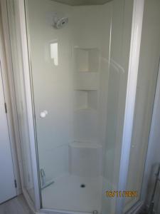 a shower with a glass door in a bathroom at City Stay in Christchurch
