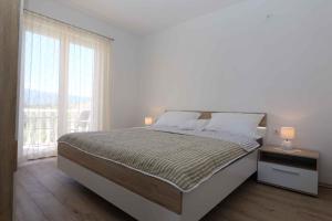 a bedroom with a large bed and a window at Apartment in Silo - Insel Krk 41833 in Šilo