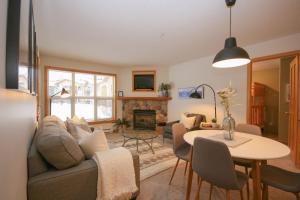 a living room with a couch and a table at CRYSTAL FOREST 2BR Ski In Ski Out with PRIVATE Hot Tub in Sun Peaks
