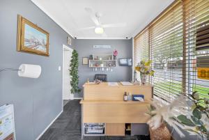 una oficina con escritorio de madera y ventana en Central Wangaratta Motel, en Wangaratta