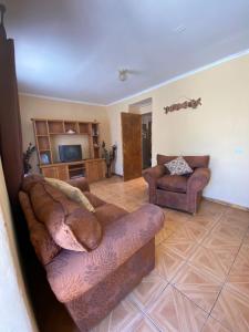 a living room with two couches and a television at Casa grande Campestre, Vicuña, Valle del Elqui in Vicuña