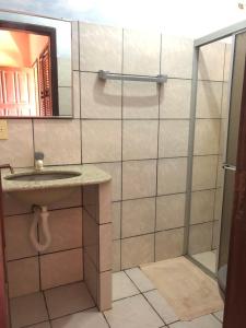 a bathroom with a shower and a sink and a mirror at Bela Vista in Canoa Quebrada