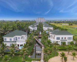 an aerial view of a resort with palm trees at Le Palmier Ho Tram Resort - Beachfront with Private Beach in Ho Tram