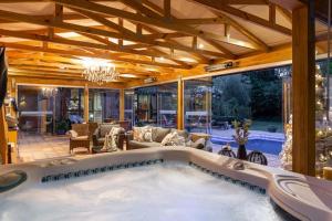 a large swimming pool in a house with a living room at Picton Country Hideaway in Picton