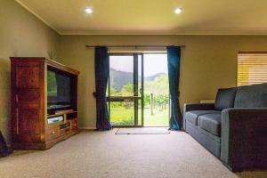 a living room with a couch and a television at Picton Country Hideaway in Picton