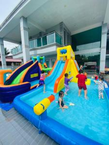 a group of children playing in an indoor water park at DD Empire Homestay in Kuala Selangor
