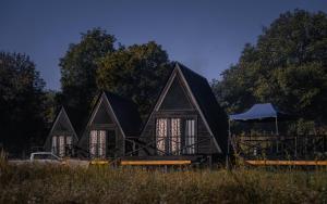 a house with a pitched roof in a field at HAERI • Utsera Cabins • Racha in Utsera