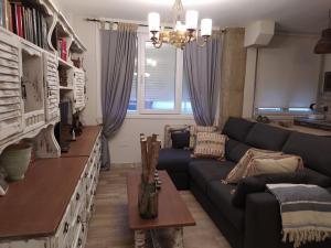 a living room with a couch and a table at Iregua Playa in Laredo