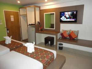 a hotel room with a bed and a tv at D2 lamoon resotel in Phuket