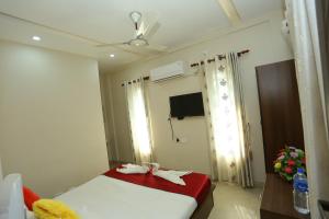 a bedroom with a bed with towels on it at Hotel Innate Inn in Alwaye