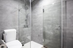 a bathroom with a glass shower with a toilet at Kona Stay Bicycle Resort in Izunokuni