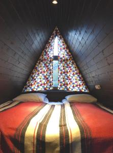a bed in a room with a large window at HAERI • Utsera Cabins • Racha in Utsera +56 photos