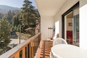 a balcony with a table and chairs and a view at Royal Center in Brides-les-Bains