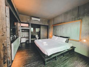 a bedroom with a large bed in a room at BED STOP Hotel Chiangmai in Chiang Mai