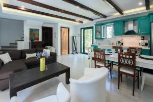 a living room with a couch and a table at Spitaki Pool House & Spitaki Jacuzzi Deluxe Suite in Corfu