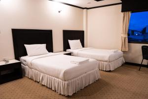 Säng eller sängar i ett rum på Betong Hello Hotel
