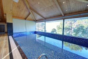 a swimming pool with a view of the water at Best Western Plus Revanta Mcleod Ganj in Dharamshala