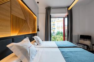 a hotel room with a bed and a window at Hotel Sevilla in Seville
