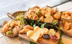 a table topped with lots of different types of bread at HOTEL RELIEF Sapporo Susukino in Sapporo