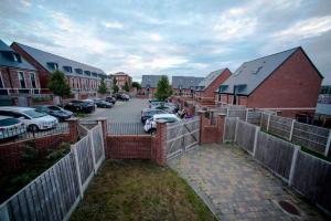 a residential neighborhood with cars parked in a parking lot at A Cosy 3-bed Family House in Liverpool sleeps 6 with parking spaces in Liverpool
