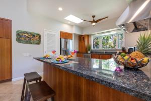 a kitchen with a counter with a bowl of fruit on it at Lanai Villas 38 in Koloa