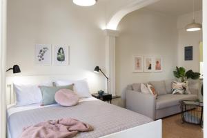 a bedroom with a bed with a pink blanket on it at Effie's cozy old town studios in Rethymno