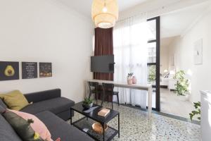 a living room with a couch and a table at Effie's cozy old town studios in Rethymno Town