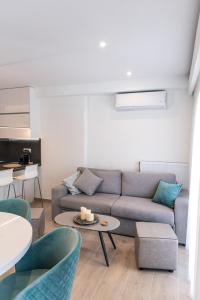 a living room with a couch and a table at Amelia Luxury Living in Volos