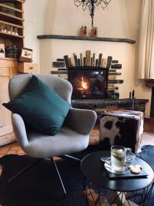 a living room with a chair and a fireplace at Wildstrubel Lodge in Adelboden