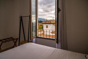 Säng eller sängar i ett rum på Florentia San Nicolás