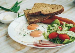 a plate of eggs and toast with a salad and vegetables at The CHU cafe / guesthouse in Nai Harn Beach