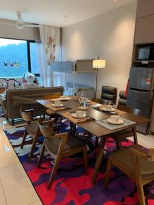a dining room with a table and some chairs at Genting Geo38 Residence Snoopy Studio in Genting Highlands
