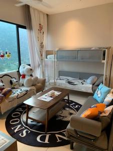 a living room with a room with bunk beds at Genting Geo38 Residence Snoopy Studio in Genting Highlands