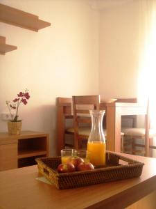 a tray of fruit and a bottle of orange juice at Apartamentos Margoysa I in Los Alcázares