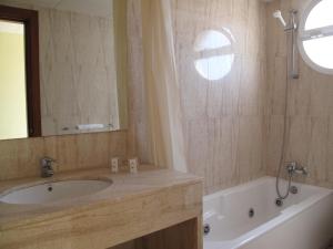 a bathroom with a sink and a tub and a mirror at Hotel Reymar in Malgrat de Mar