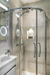 a bathroom with a shower and a sink at The Crescent Hyde Park in London