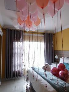 a bedroom with pink balloons hanging from the ceiling at LANGA 'S COZY GUESTHOUSE in Pretoria