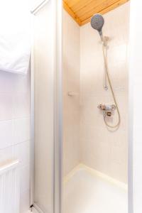 a shower with a shower head in a bathroom at Haus Suban in Längenfeld