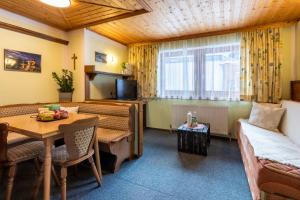a living room with a table and a couch at Haus Suban in Längenfeld