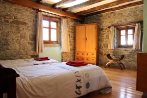 a bedroom with two beds and two windows at Casa Rural Ardantzena in Ardaiz