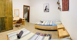 a bedroom with a bed and a desk and a table at Family House Apartma in Mozirje