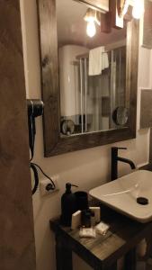 a bathroom with a sink and a mirror at MadeBoutique Rooms in Madesimo