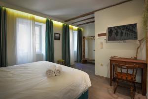 a bedroom with a large bed and a large window at Locandiera in Corfu Town