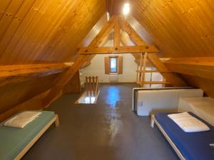a room with two bunk beds in a wooden attic at Après l'école, appartement de charme in Oz