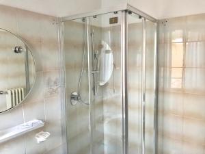 a bathroom with a shower stall and a toilet at Garnì Hotel Tignale, GTSGroup in Tignale