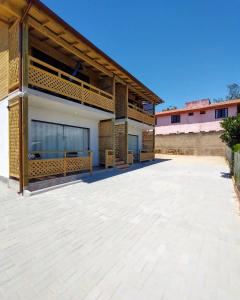 a building with a large patio in front of it at SUÍTES PRAIA DO ROSA in Imbituba +19 photos