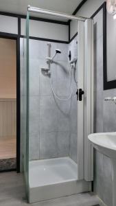 a shower with a glass door in a bathroom at The Dunes Camping & Safari RAK in Ras al Khaimah